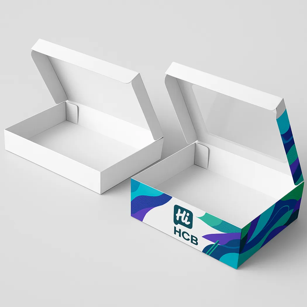 Two flat rectangular food boxes with windowed lids- one plain white and one teal branded- class=